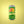Green can with a hand holding a lemon on a yellow background